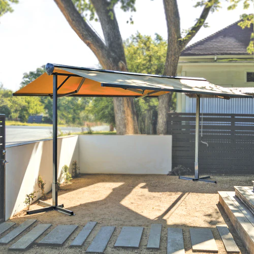 Free-standing awning system for flexible outdoor shade without wall mounting.
